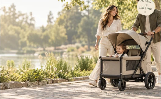Family enjoying an outdoor stroll with a baby wagon